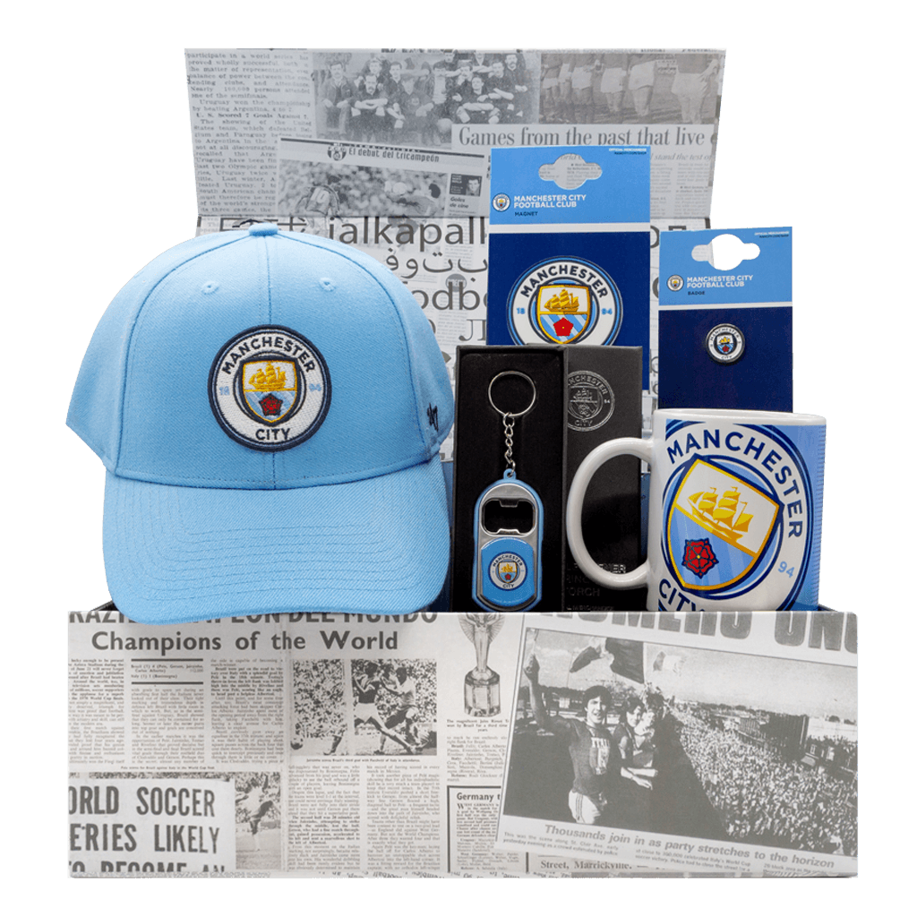 The Man City Supporters 1894 gift box with a cap, mug, pin, magnet, and bottle opener.